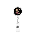 Close-up of retractable badge holder with black floral letter E and metal clip - Letter E