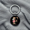 Detail of round metal keychain featuring an elegant golden letter F with floral accents - Letter F