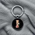 Detail of metal keychain featuring letter L with pink roses and daisies on black background - Letter I