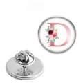 Silver stainless steel floral letter D brooch with butterfly pin back on white background - Letter D