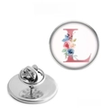 Macro detail of 25mm stainless steel floral letter L brooch with clutch pin back - Letter L