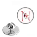 Detail view of round metal brooch with floral letter N design and butterfly clasp backing - Letter N