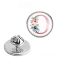 Detail of round stainless steel brooch with pink letter O and delicate floral design - Letter O