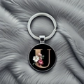 Detailed view of silver keychain with a black floral pendant featuring a golden letter U - Letter U