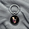 Detail of silver metal keychain with letter V pendant featuring pink and purple floral patterns - Letter V