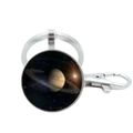 Detailed close-up of a silver metal keychain with a Saturn planet glass dome pendant - Saturn
