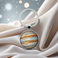 Macro shot of Jupiter planet crystal keychain on luxury satin with bokeh lighting effects - Jupiter