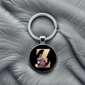 Detailed close-up of a metal keychain with a floral gold letter Z on a plush background - Letter Z