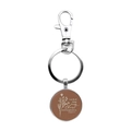 Close-up of silver metal keychain with Bible quote Philippians 4:13 on glass pendant - Philippians 4:13 Brown Background Floral Style