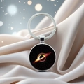Macro shot of silver metal keychain with a deep black hole accretion disk pendant - Black Hole