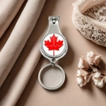 Detail of a Canada flag nail clipper keychain with red maple leaf and city skyline - Style 5