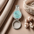 Macro view of motivational nail clipper keychain with blue watercolor design and silver finish - Light Blue Watercolor Inspirational Phrase Style(8)