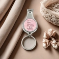 Close-up of a silver nail clipper keychain featuring a pink inspirational love quote - Pink Round Inspirational Quote Style(9)