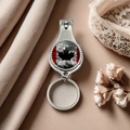Detail view of Canadian flag maple leaf nail clipper and bottle opener keychain on silk - Style 17