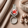 Detail of metal nail clipper keychain with Canadian flag design on elegant fabric - Style 21