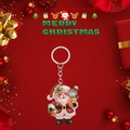 Close-up of 2D acrylic Christmas Santa Claus and snowman keychain on festive background - Santa Hugging Snowman Style