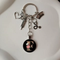 Detail of medical keychain with heart, stethoscope charms and floral letter F pendant - Letter F
