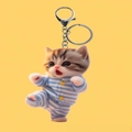 Cute acrylic kitten keychain featuring a ginger cat in blue striped pajamas on yellow - Blue Striped Pajama Cat Style 1 (1)