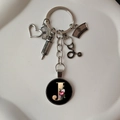 Detail of medical keychain with silver stethoscope, heart, nurse hat and letter J charm - Letter J