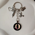 Detailed view of silver medical keychain with stethoscope and floral letter D pendant - Letter O