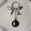 Detailed silver stethoscope keychain with medical charms and floral letter U pendant - Letter U