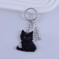 Detail of cartoon black cat keychain with acrylic finish and silver fish bone charm - Black Kitten with Blue Eyes Style