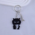Close-up of black resin cat keychain with coffee cup and small metal fishbone charm - Black Cat Holding Coffee Cup Style
