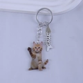 Detail of cute ginger cat keychain with silver metal split ring and fishbone pendant charms - Sitting Orange Cat Waving Style