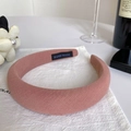 Detail of pink sponge headband featuring a handmade label and ribbed fabric texture - Lotus Pink (C-1214-1)