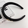 Elegant black satin padded headband featuring gold vintage-style metal emblems - Black