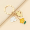 Detailed view of golden metal keychain featuring enamel rabbit, bear and smiling flower charm - Rabbit And Sun Flower Style (7)