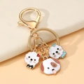 Simpatico portachiavi a forma di cane con ciondoli in smalto e anello dorato - Stile Cane Farfallino Blu (1)