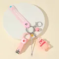 Pink pig keychain set with nail clipper, ear pick, and silicone strap on a tray - Pink Pig Theme