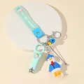 Detail view of duck keychain set with nail clipper, ear pick and green silicone wristlet - Mint Green Duck Theme