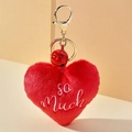 Detail eines roten Plüsch Herz Schlüsselanhängers mit so Much Stickerei und Goldring - So Much Stil