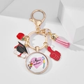 Detail of keychain with Merci maitresse charm, red enamel apple, and pink tassel decoration - French Thank You Teacher Merci maitresse (7)