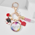 Detail of teacher keychain with red apple, graduation cap, and pink leather tassel pendants - Colored Pencil Inspirational A great teacher (6)