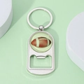Close-up of a silver metal American football bottle opener keychain with glossy finish - American Football Style