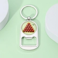 Close-up of silver metal sports keychain featuring a billiard ball design and bottle opener - Red Ball Billiards Style