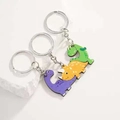 Set di tre simpatici portachiavi in legno a forma di dinosauro viola giallo verde - Portachiavi Famiglia di Dinosauri