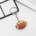 Brown American football keychain charm with white stitching on silver metal ring - Rugby Ball