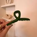 Detailed view of a dark green velvet hair claw clip held in hand with a soft velvet finish - Cross / Green