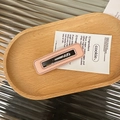 Close-up of pink leather rectangular hair clip with delicate white hand-stitched borders - Pink