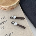 Close-up of hair clips set featuring grey faceted crystal and irregular white faux pearl - Brown