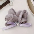 Elegant purple pleated scrunchie with a satin bow, pearl, and crystal on light background - Purple