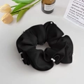 Detail of a black satin scrunchie with white pearl accents on a clean aesthetic background - Scrunchie / Black