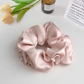 Close-up of pink satin scrunchie with silk luster and delicate white pearl decorations - Scrunchie / Pink