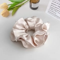 Close-up of champagne gold satin scrunchie featuring elegant white pearl bead edges - Scrunchie / Apricot