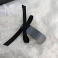 Dettaglio di un fermaglio vintage in metallo con fiocco nero su tessuto di pizzo bianco - Stile Fiocco Canna di Fucile Nero (D-5317-3)