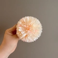 Detail shot of multi-layer pale pink floral hair clip with realistic fabric petals - Champagne Pompon Mum
